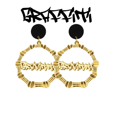 An image of Haus of Dizzy's large gold bamboo hoops with 'Graffiti' text in graffiti font, with matte black circle tops.