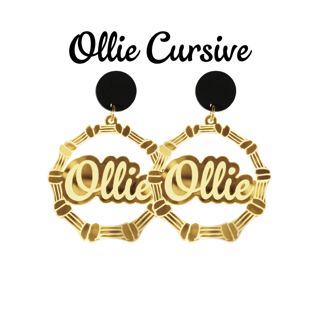 An image of Haus of Dizzy's large gold bamboo hoops with 'Ollie cursive' text in ollie cursive font, with matte black circle tops.