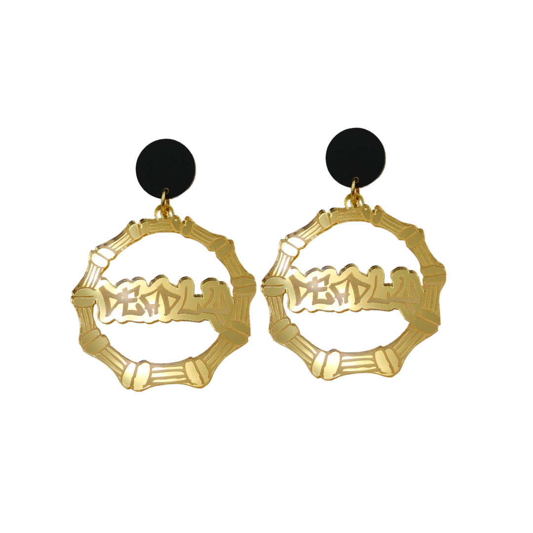 An image of Haus of Dizzy's small gold mirror bamboo hoops with 'Deadly' text in graffiti font, with matte black circle tops.