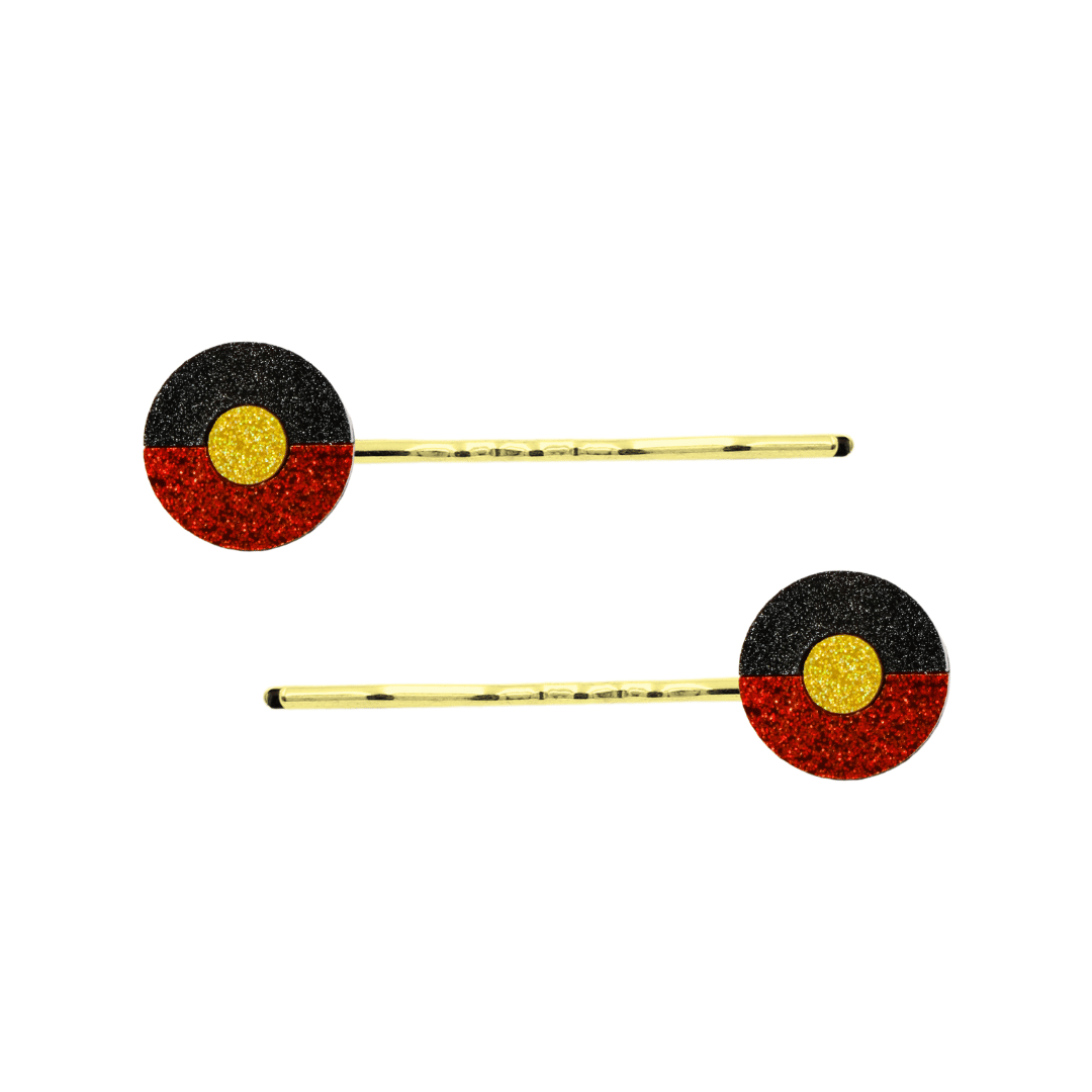 An Image of Haus of Dizzy's Circle Shaped Glitter Aboriginal Islander Flag Hair Pins. Flags are on Gold Pins
