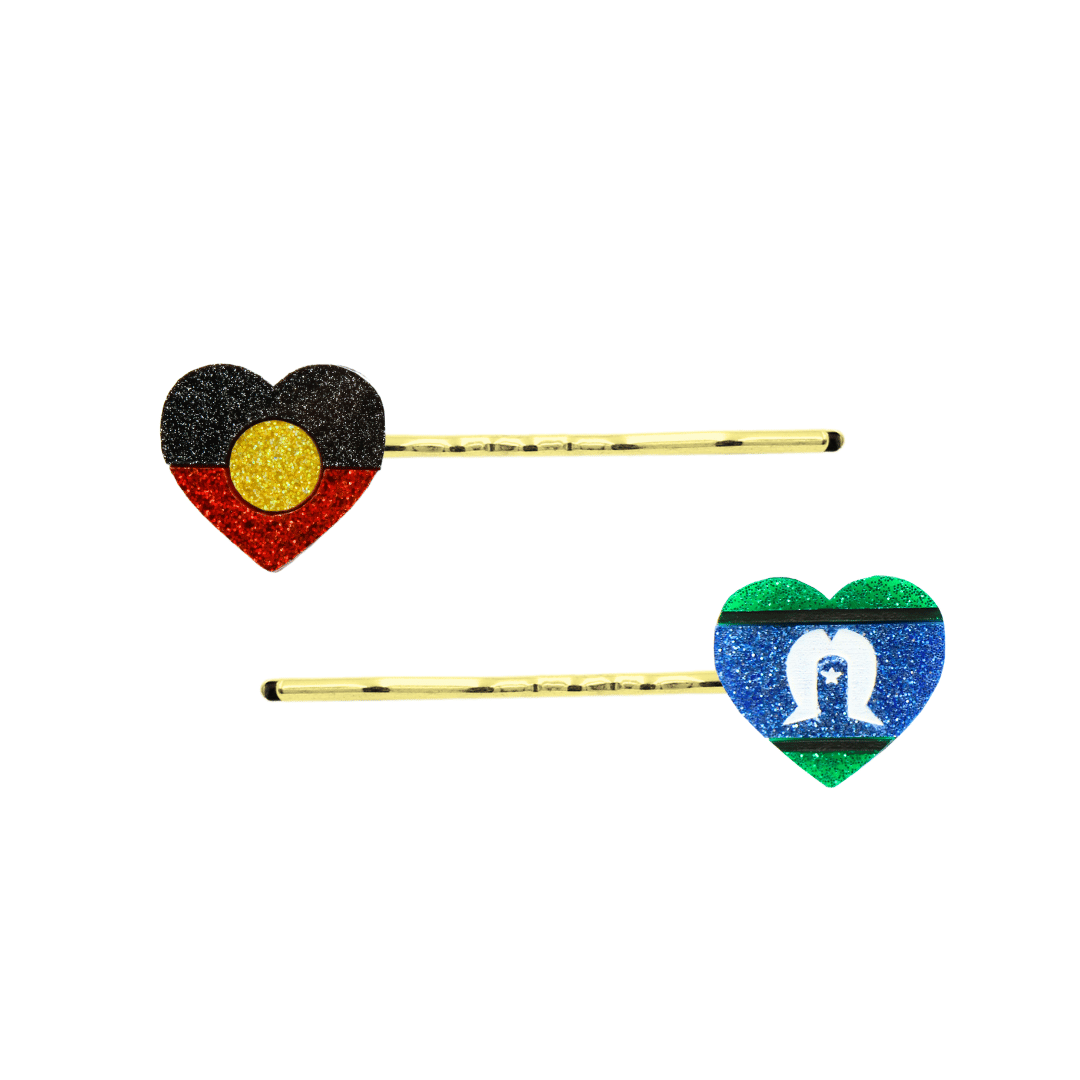 An Image of Haus of Dizzy's Heart Shaped Glitter Aboriginal and Torres Strait Islander Flag Hair Pins. Flags are on Gold Pins