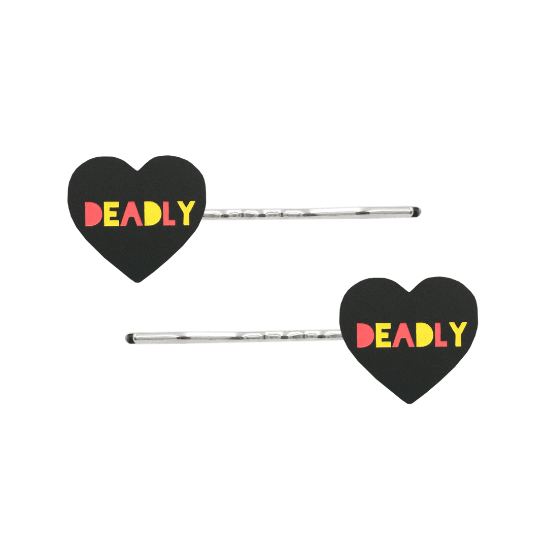 An Image of Haus of Dizzy's Black Acrylic Heart Shaped Hair Pins with "Deadly" text in Red and Yellow. Hearts are on Silver Pins