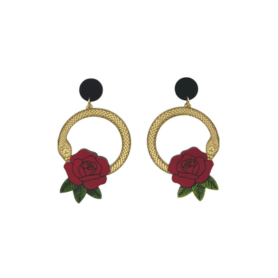 An image of Haus of Dizzy's small Snake Rose hoop dangle earrings, featuring a gold snake in a circle with a blood red rose and matte black circle top.