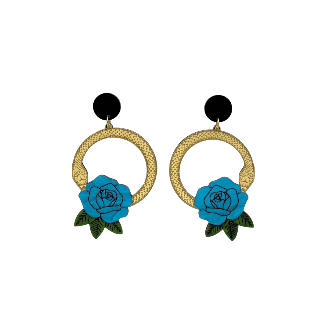 An image of Haus of Dizzy's small Snake Rose hoop dangle earrings, featuring a gold snake in a circle with a cyan blue rose and matte black circle top.