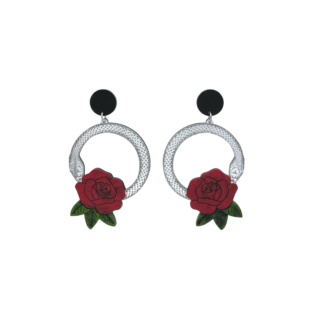 An image of Haus of Dizzy's small Snake Rose hoop dangle earrings, featuring a silver snake in a circle with a blood red rose and matte black circle top.