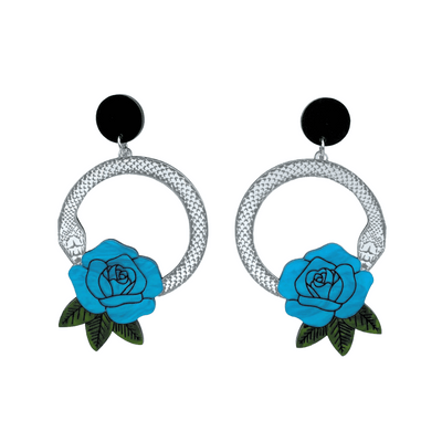 An image of Haus of Dizzy's large Snake Rose hoop dangle earrings, featuring a silver snake in a circle with a cyan blue rose and matte black circle top.