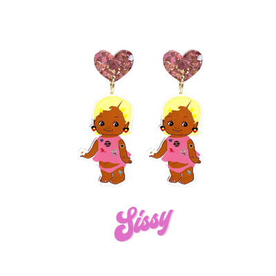 An image of Haus of Dizzy's Dizzy Chicks acrylic dangle earrings, with a doll with Short length Blonde Wavy hair in a Rose Pink colour Playset and Aboriginal Flag earrings on a Rose Pink crinkle glitter heart top. Pink Colour "Sissy" Cursive Text is at the bottom of the image. 