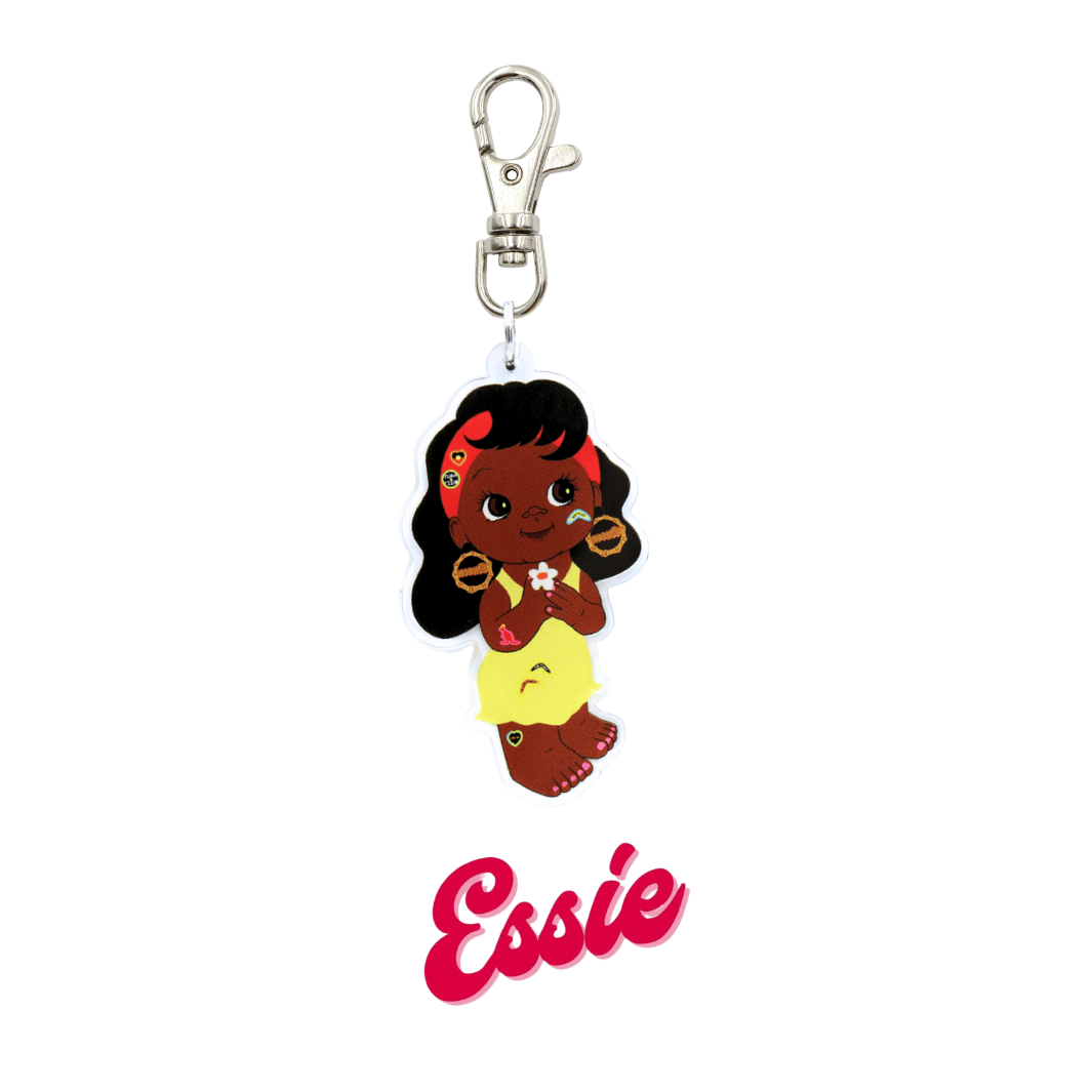 An image of Haus of Dizzy's Dizzy Chicks acrylic keyring, with a doll with medium length Dark Brown Wavy hair in a Yellow Dress and bamboo queen earrings on a parrot clasp. Red Colour "Essie" Cursive Text is at the bottom of the image.