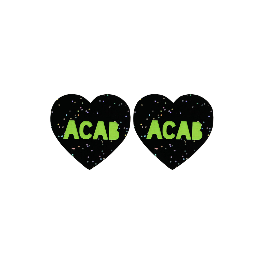 An image of Haus of Dizzy's Small ‘ACAB’ heart shaped dangle earrings, with Apple Green “ACAB” text on a Black Glitter acrylic stud heart.