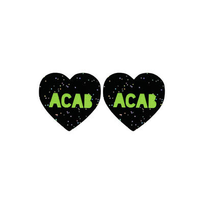 An image of Haus of Dizzy's Small ‘ACAB’ heart shaped dangle earrings, with Apple Green “ACAB” text on a Black Glitter acrylic stud heart.