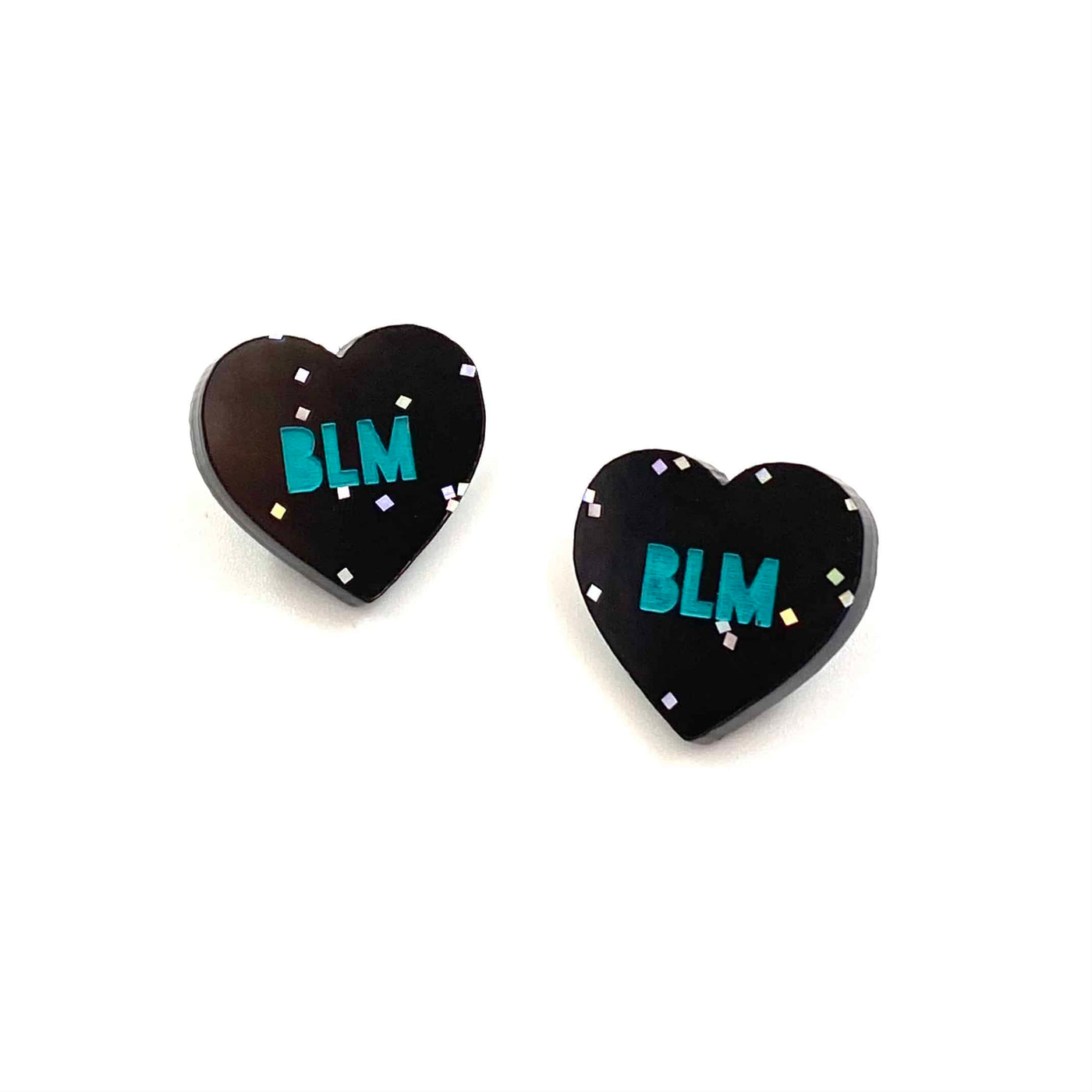 Image of Haus of Dizzy's acrylic black glitter etched studs with blue 'BLM' paint fill text.