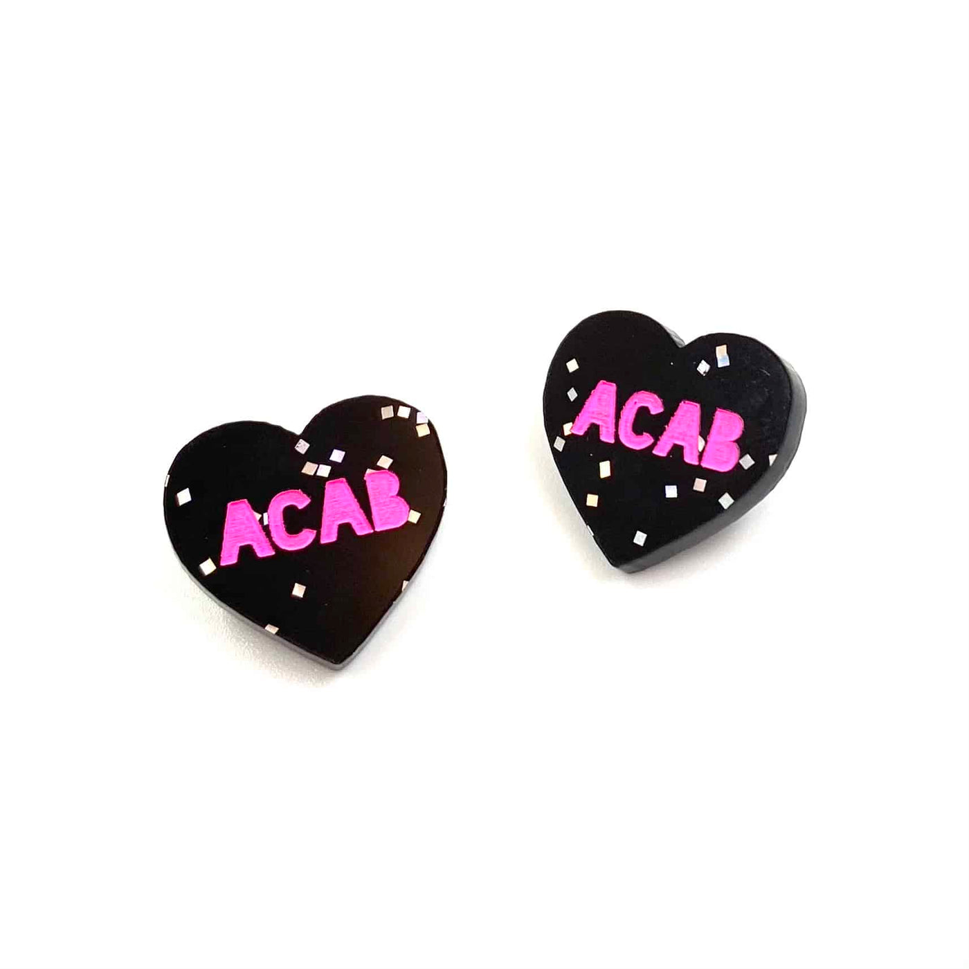 Image of Haus of Dizzy's acrylic black glitter etched studs with PINK 'ACAB' paint fill text.