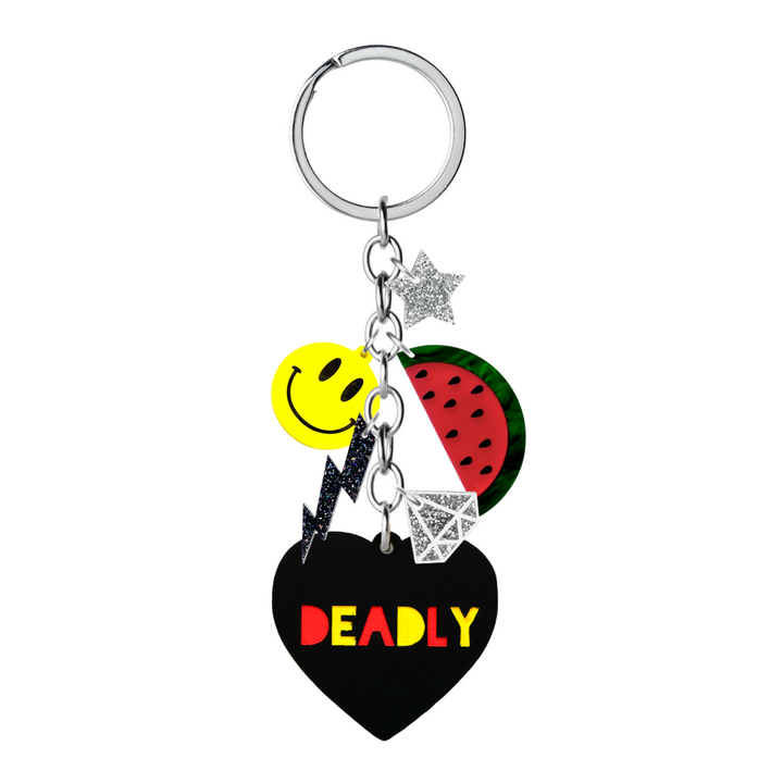 Pictured is the Limited Edition Deadly Charm Keychain with hand-painted charms, including a smiley face, watermelon, and 'Deadly' heart, along with glitter accents.