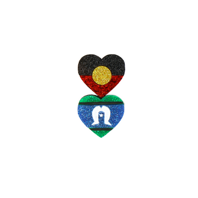 An image of Haus of Dizzy's hand-painted, double heart lanyard pin with stacked Aboriginal and Torres Strait Islander flags on glitter acrylic.