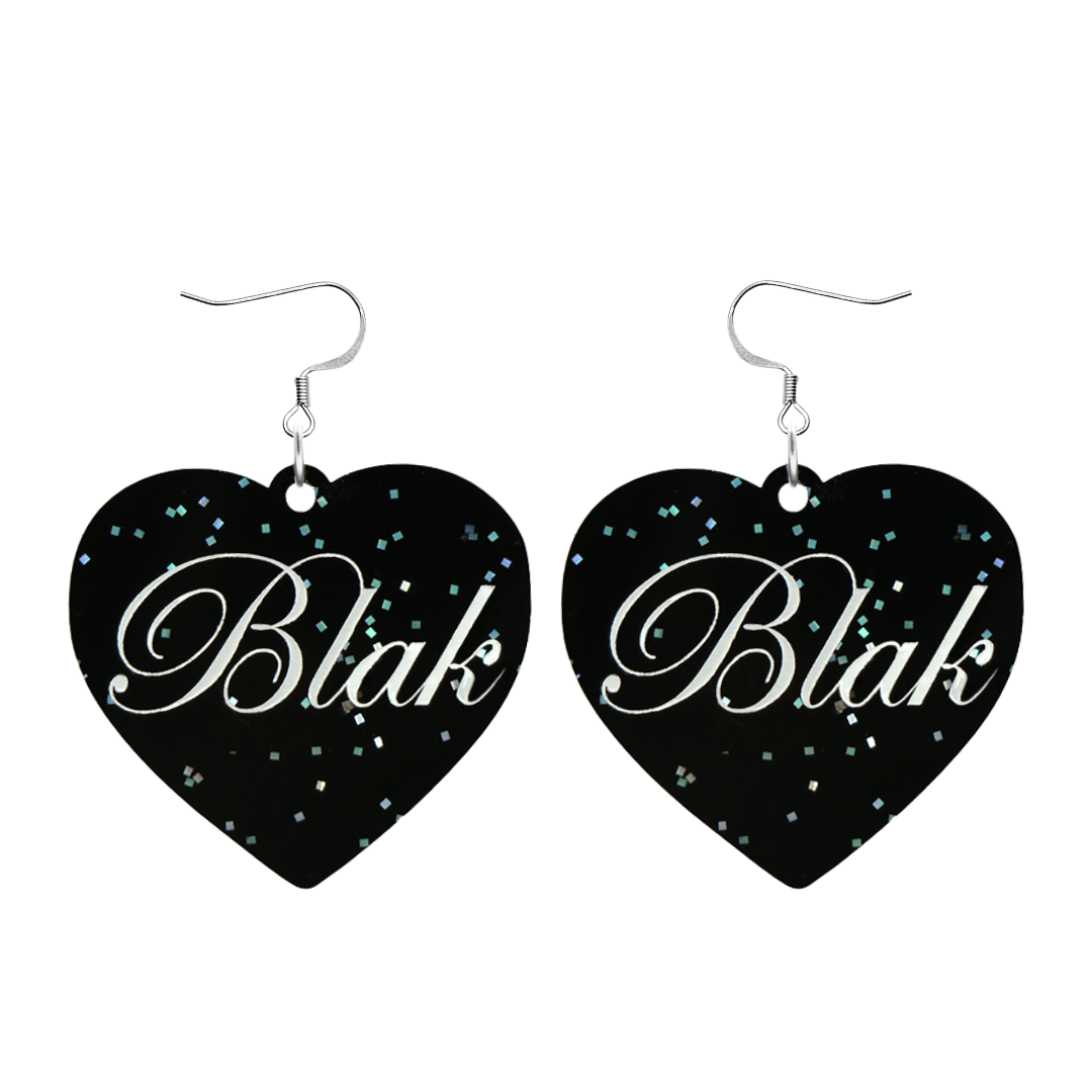 Black glitter Heart-shaped earrings with white 'Blak' text and silver hooks (no heart tops) on a white background