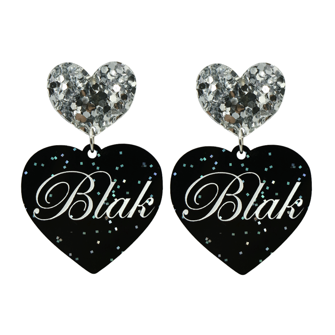 Black glitter heart-shaped earrings with silver glittery heart tops and 'Blak' written on them in white text