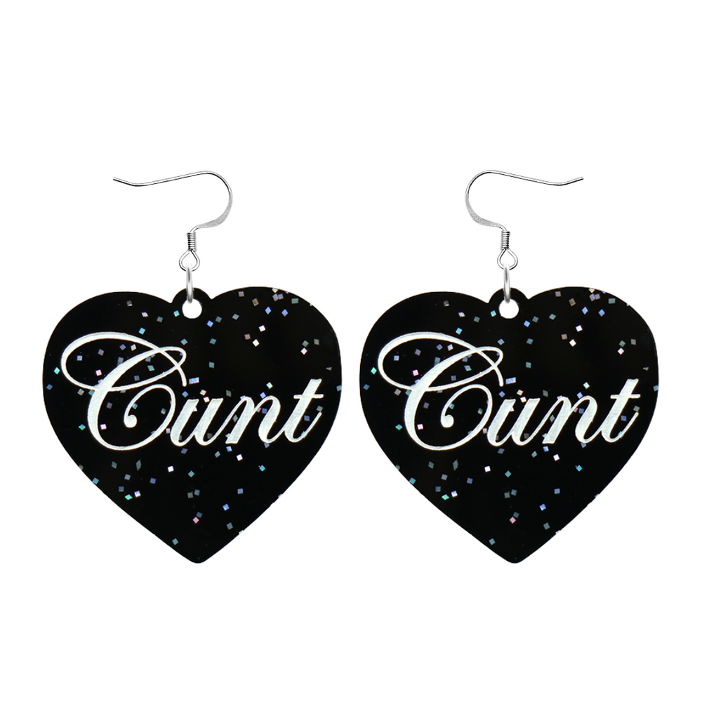 Black glitter Heart-shaped earrings with white text that says 'Cunt', and silver hooks (no heart tops) on a white background