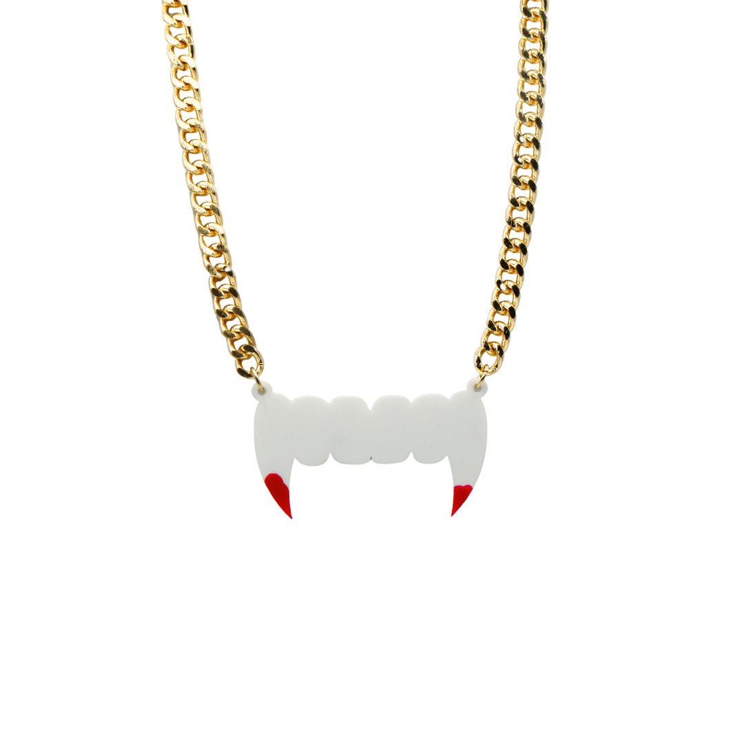 haus of dizzy necklace with white fang pendant and red paint blood accents on a gold chain against a white background