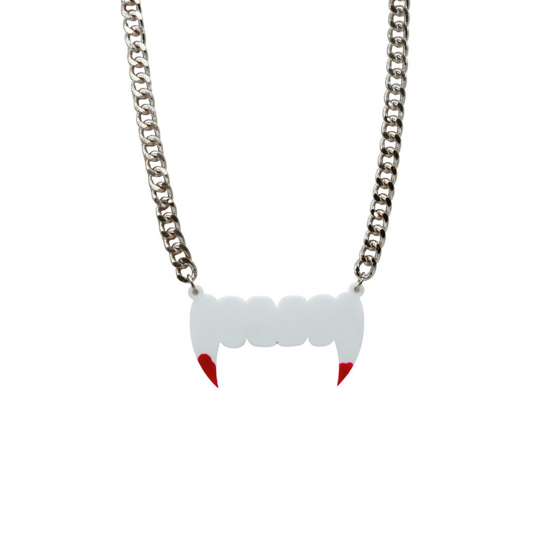 haus of dizzy necklace with white fang pendant and red paint blood accents on a silver chain against a white background