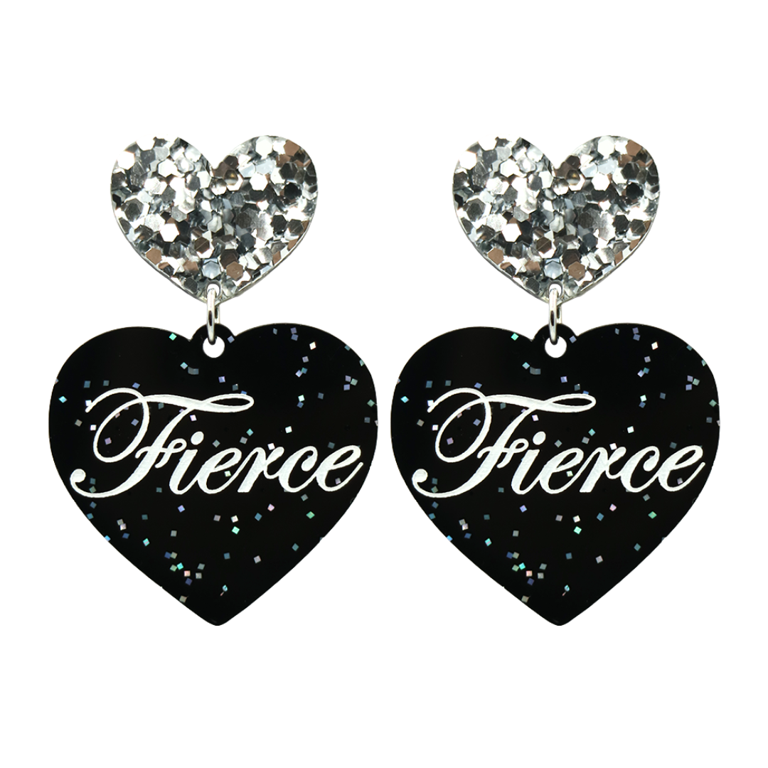 Black glitter Heart-shaped earrings with white text that says 'Fierce', and silver glitter heart tops on a white background