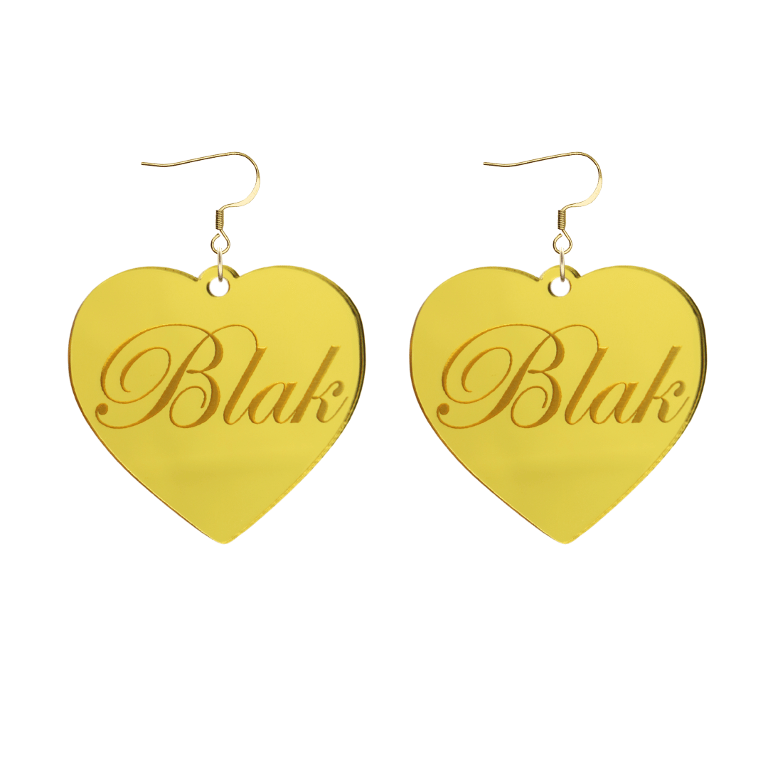 Heart-shaped gold mirror acrylic earrings with 'Blak' engraving on a white background