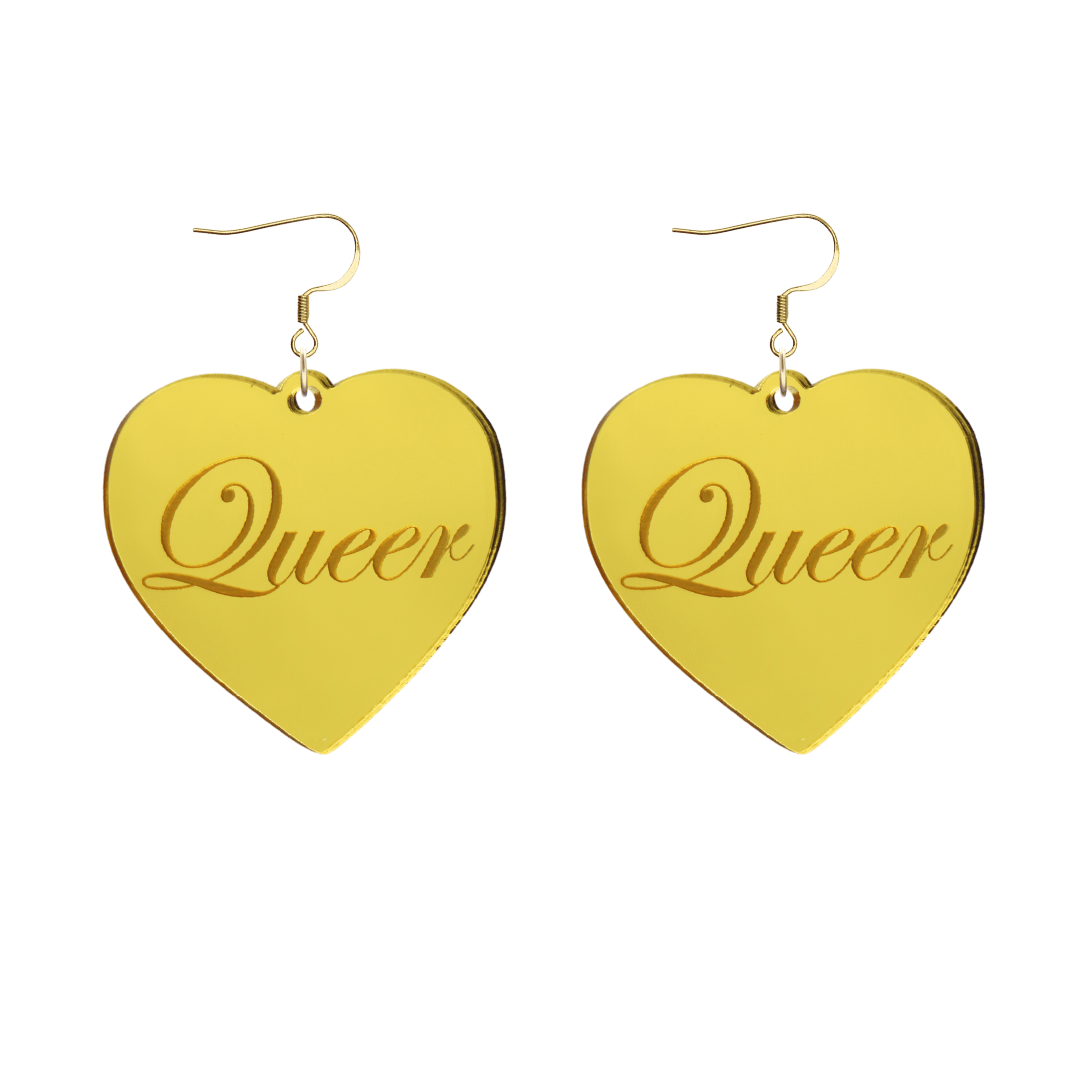 Heart-shaped gold mirror acrylic earrings with 'Queer' engraving on a white background