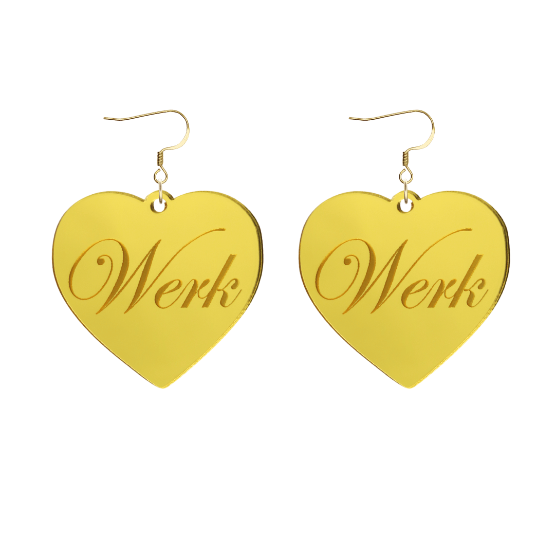 Heart-shaped gold mirror acrylic earrings with 'Werk' engraving on a white background