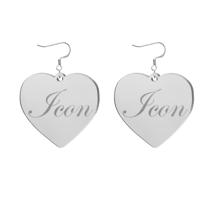 Heart-shaped silver mirror acrylic earrings with cursive script 'Icon' engraving on a white background