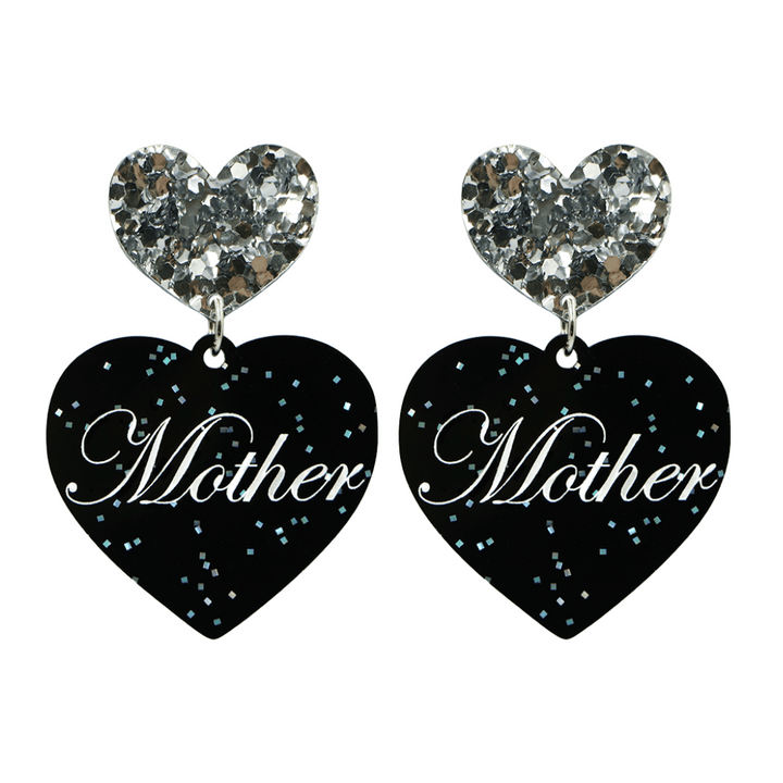 Black glitter Heart-shaped earrings with white text that says 'Mother', and silver glitter heart tops on a white background
