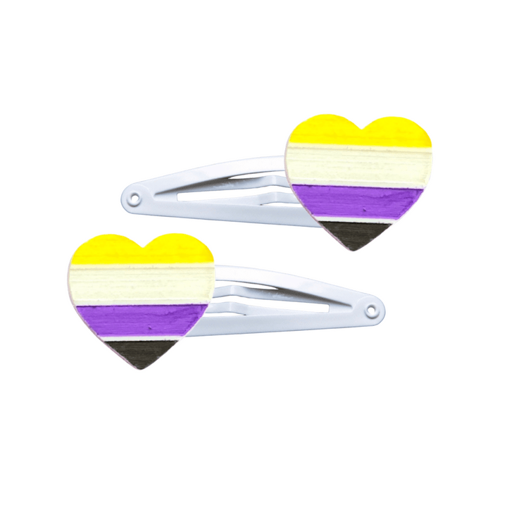 Two heart-shaped non-binary pride flag hair clips on a white background