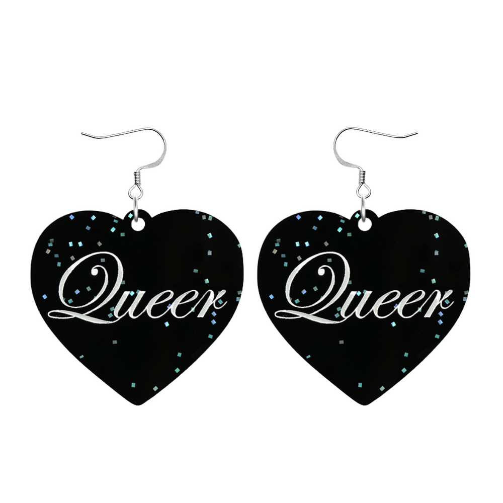 Black glitter Heart-shaped earrings with white text that says 'Queer', and silver hooks (no heart tops) on a white background