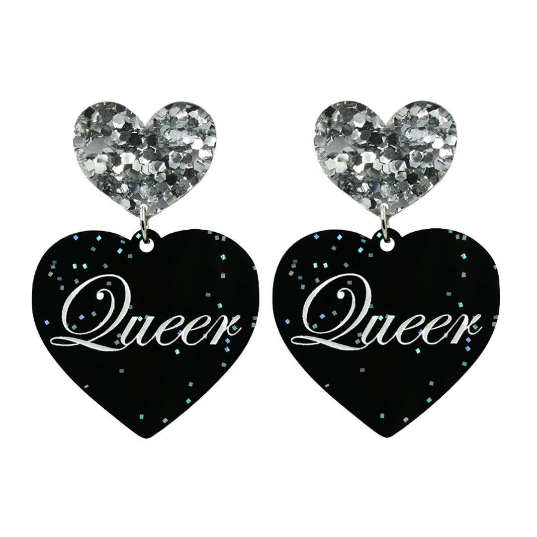 Black glitter Heart-shaped earrings with white text that says 'Queer', and silver glitter heart tops on a white background