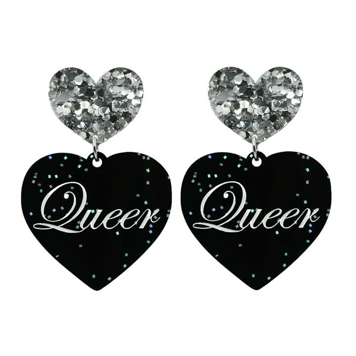 Black glitter Heart-shaped earrings with white text that says 'Queer', and silver glitter heart tops on a white background