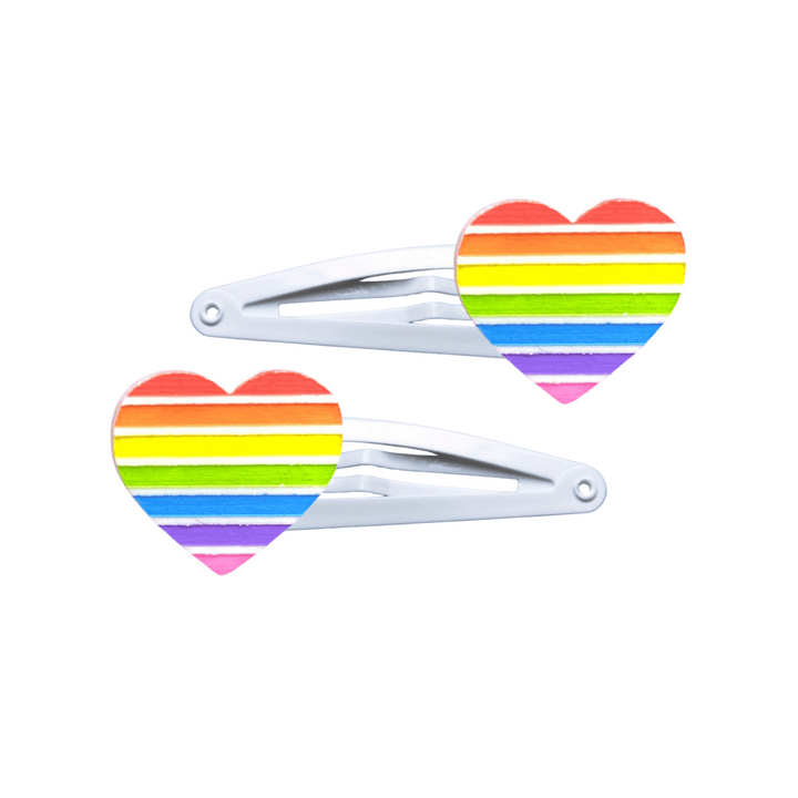 Two heart-shaped rainbow pride flag hair clips on a white background