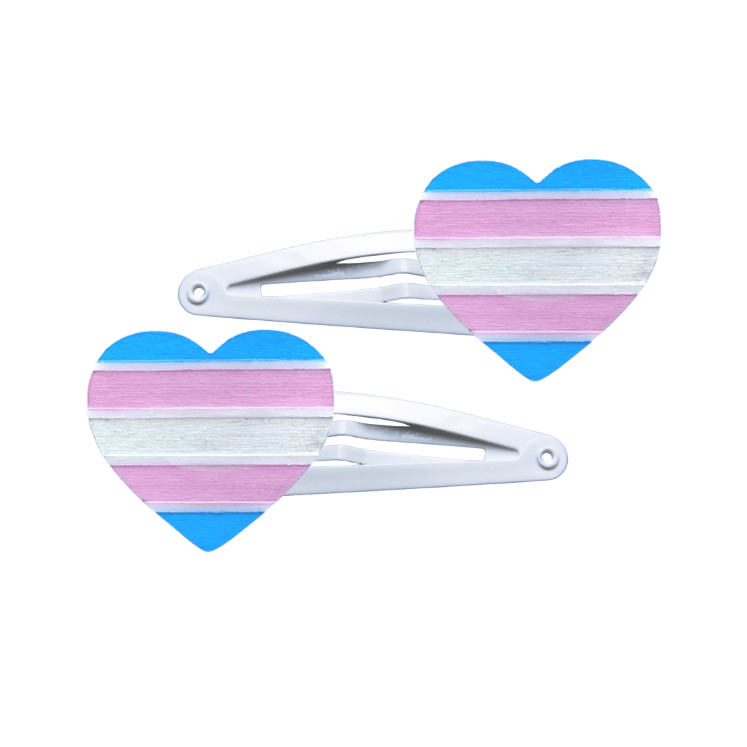 Two heart-shaped transgender pride flag hair clips on a white background