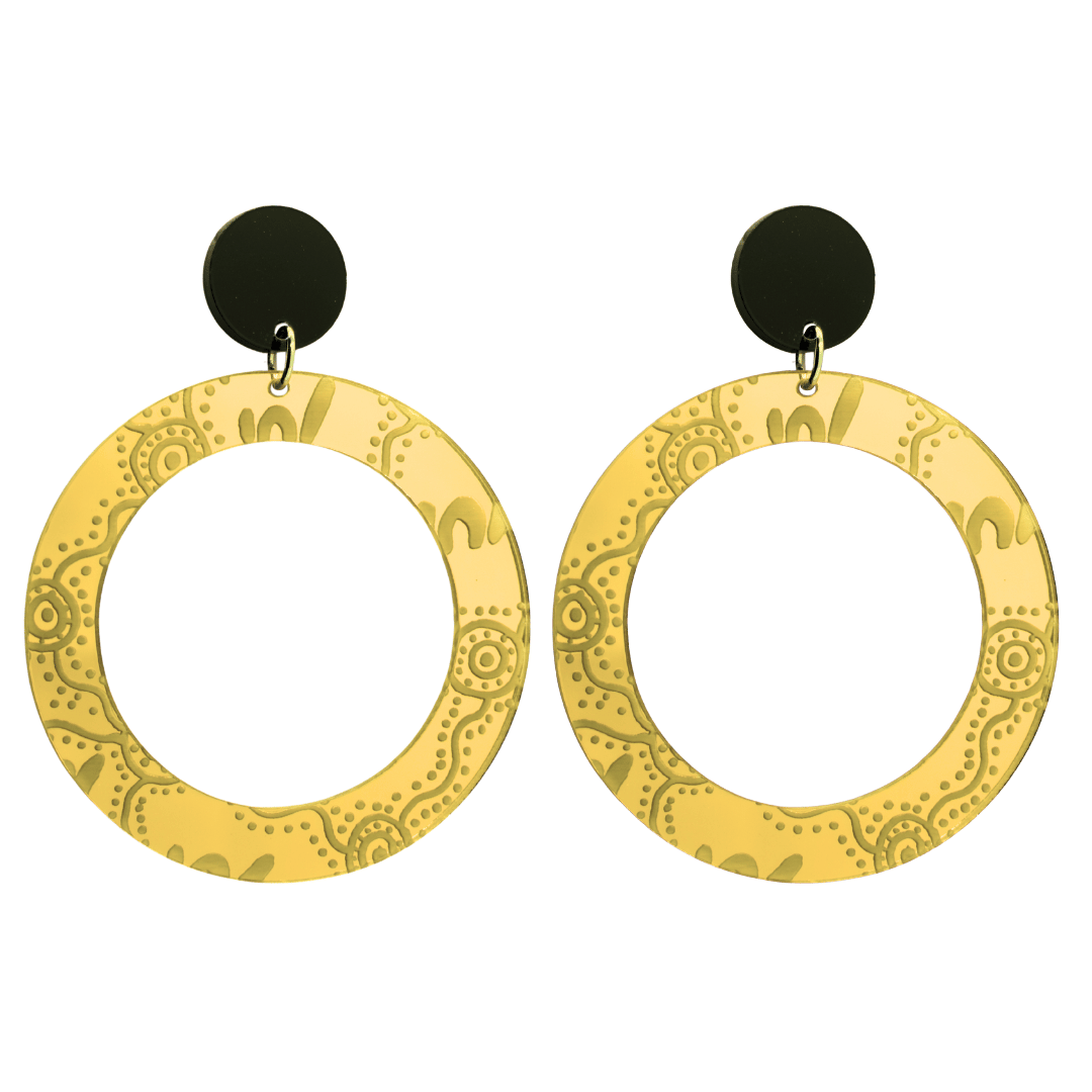 Pair of large, gold mirror, acrylic hoop earrings with Aboriginal artwork pattern with black circular earring top. Earrings are on a white background