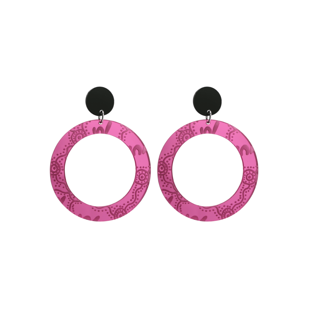 Pair of small, pink mirror, acrylic hoop earrings with Aboriginal artwork pattern with black circular earring top. Earrings are on a white background