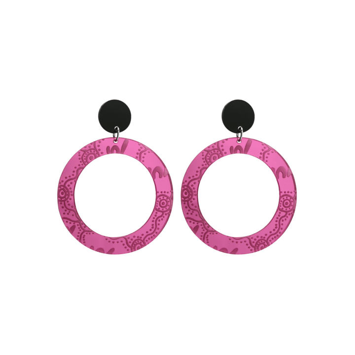 Pair of small, pink mirror, acrylic hoop earrings with Aboriginal artwork pattern with black circular earring top. Earrings are on a white background