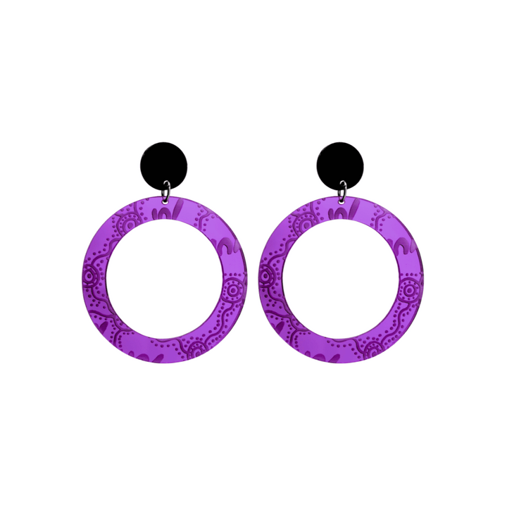 Pair of small, purple mirror, acrylic hoop earrings with Aboriginal artwork pattern with black circular earring top. Earrings are on a white background