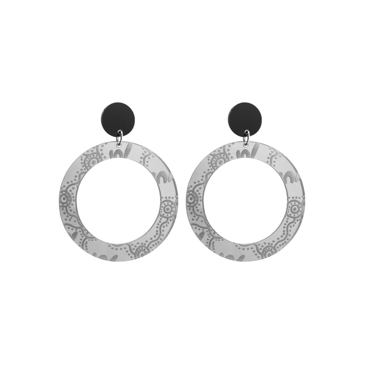 Pair of small, silver mirror, acrylic hoop earrings with Aboriginal artwork pattern with black circular earring top. Earrings are on a white background