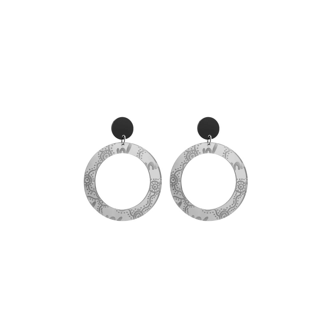 Pair of extra small, silver mirror, acrylic hoop earrings with Aboriginal artwork pattern with black circular earring top. Earrings are on a white background