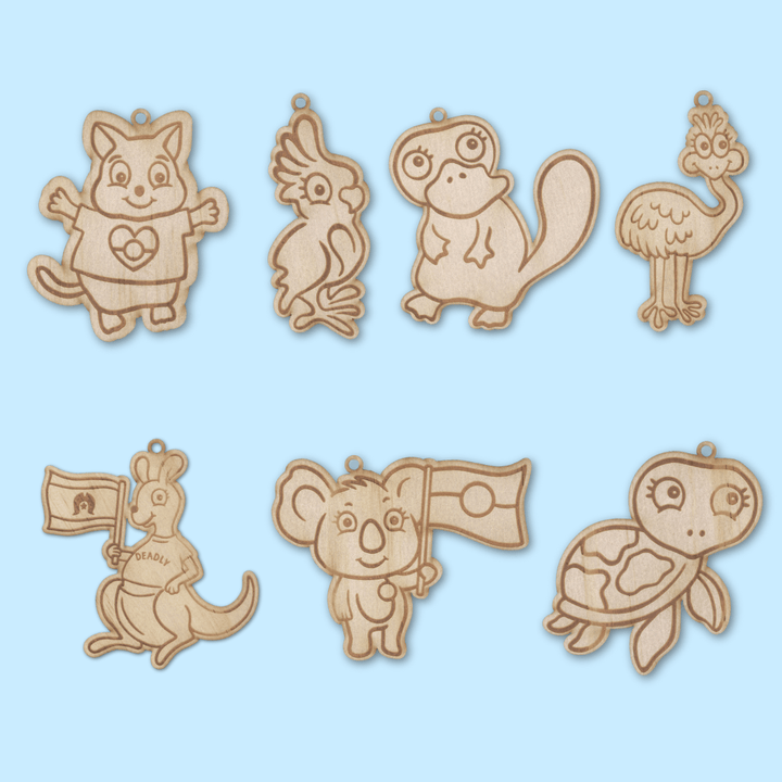 set of 7 wooden haus of ziggy lee haus of dizzy native animal colour in magnets on a light blue background