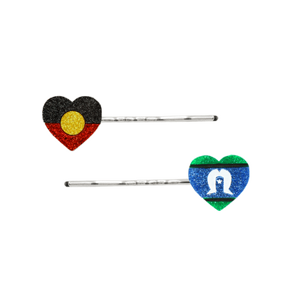 An Image of Haus of Dizzy's Heart Shaped Glitter Aboriginal and Torres Strait Islander Flag Hair Pins. Flags are on Silver Pins