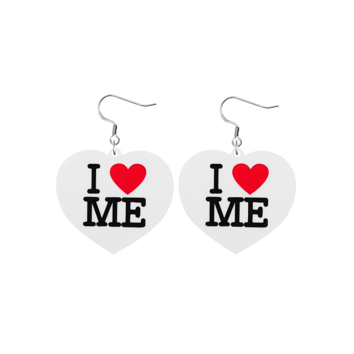 An image of Haus of Dizzy's small I Love Me heart shaped dangle earrings, with I Heart Me text on white acrylic and a hook top.