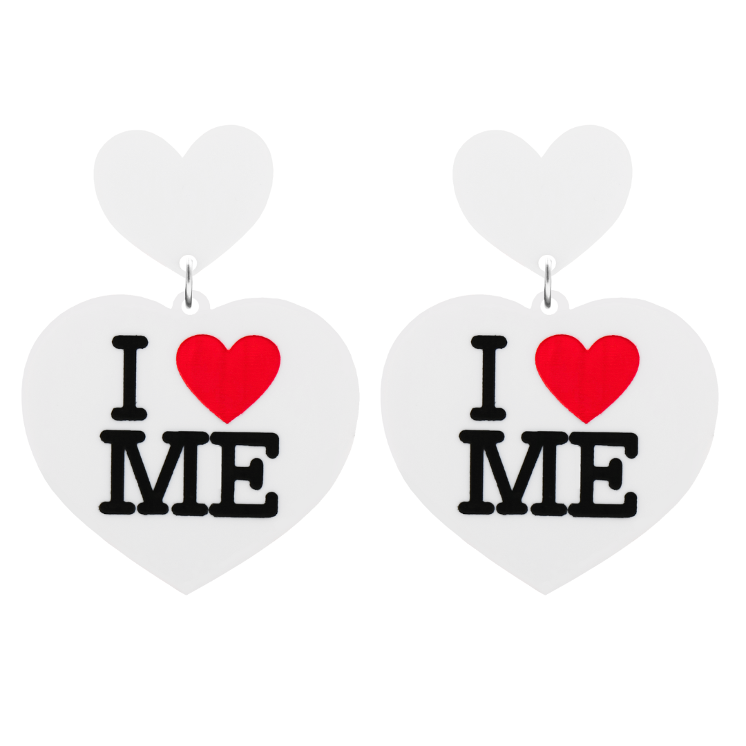 An image of Haus of Dizzy's large I Love Me heart shaped dangle earrings, with I Heart Me text on  white acrylic and a white heart top.