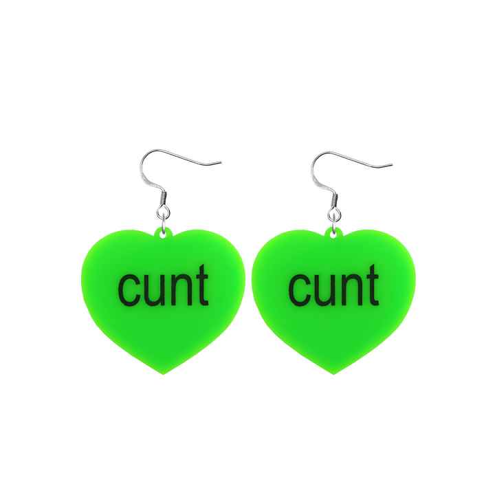 An image of Haus of Dizzy's small brat summer heart shaped dangle earrings, with cunt text on neon green acrylic and a hook top.