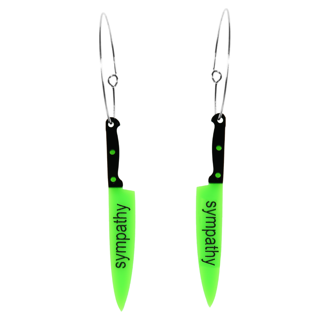 An image of Haus of Dizzy's sympathy knives, knife shaped earrings, with sympathy text on neon green acrylic with black handle on hoops.