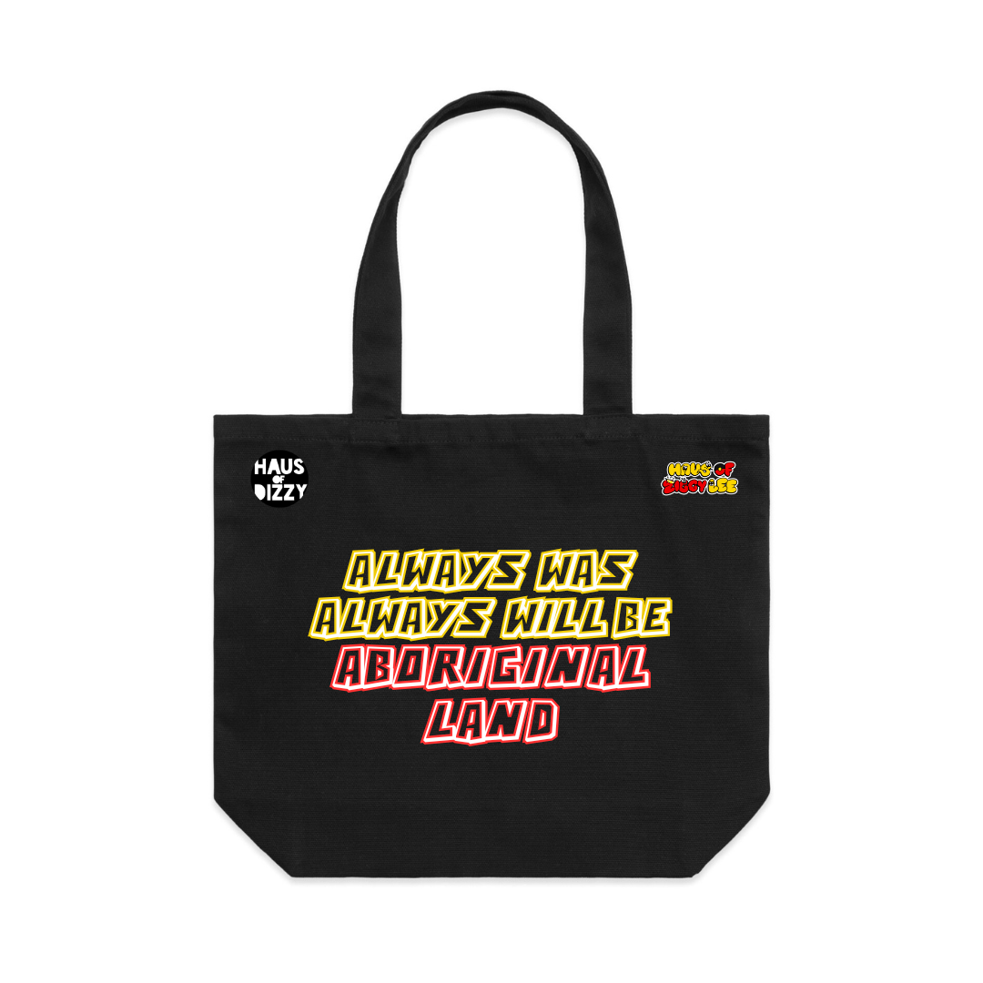 An image of Haus of Dizzy x Haus of Ziggy Lee  'ALWAYS WAS, ALWAYS WILL BE' black Tote Bag written in yellow and red with white outline. With Haus of dizzy logo on the top left and haus of ziggy lee logo on top right. 