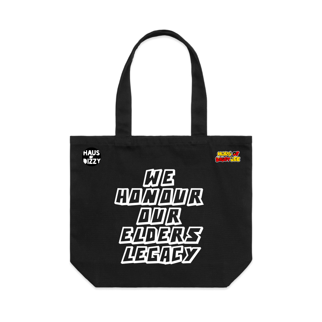 An image of Haus of Dizzy x Haus of Ziggy Lee  'HONOUR LEGACY' black Tote Bag, with white text ‘we honour our elders legacy’ in the centre and Haus of Dizzy logo on the top left and Haus of Ziggy Lee logo on top right. 