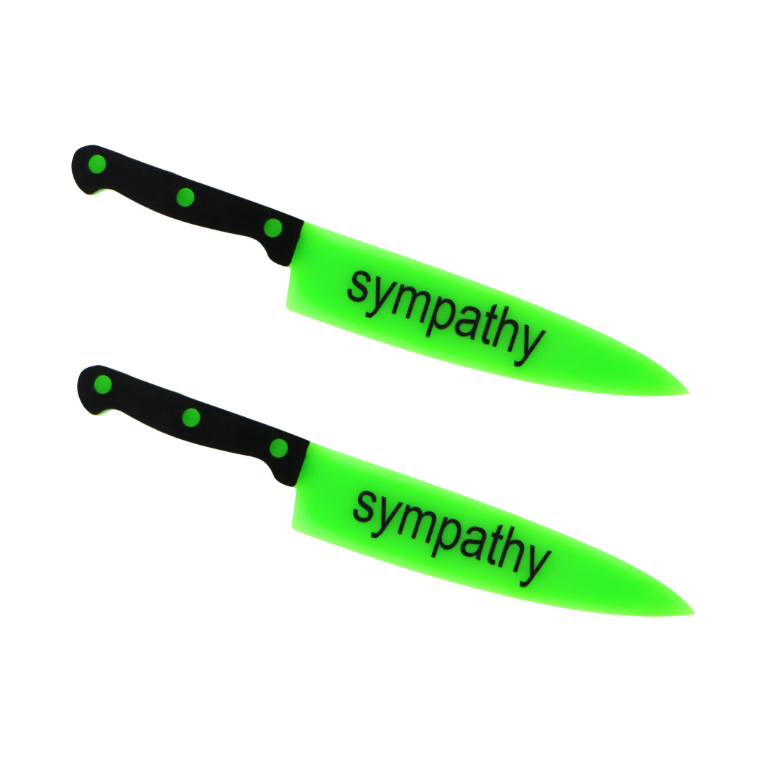 An image of Haus of Dizzy's sympathy knives, knife shaped hair clips, with sympathy text on neon green acrylic with black handle. 